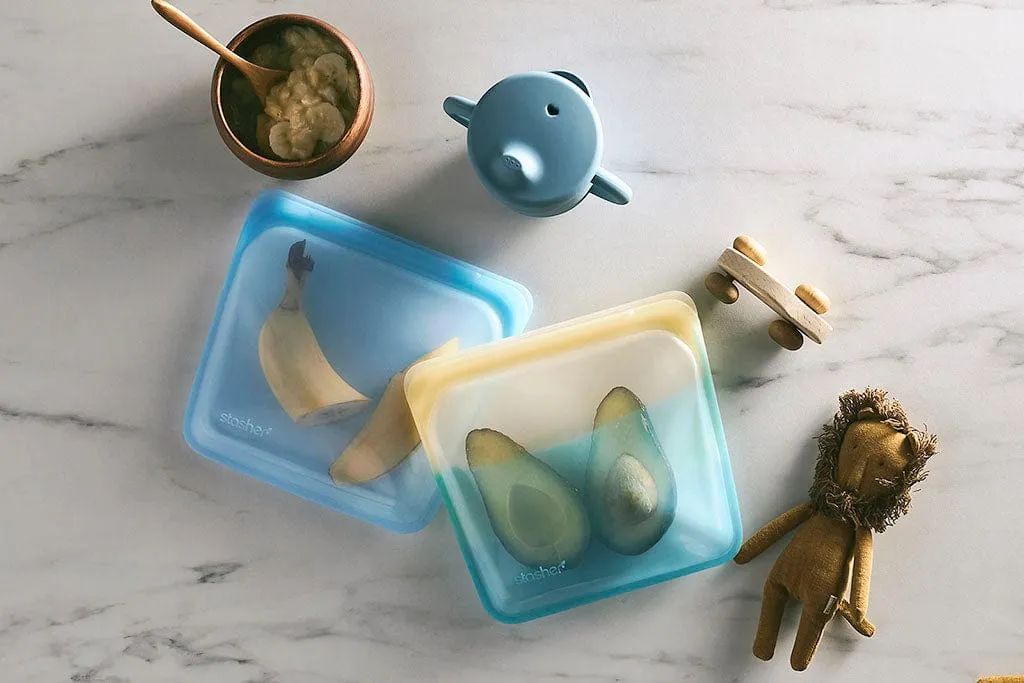 When Do Babies Start Eating Food: A Comprehensive Guide to Introducing Solids A smiling baby looking at colorful pureed foods, wondering when do babies start eating food